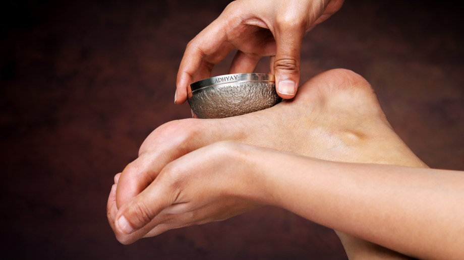 Person using a Kansa foot massager on sole